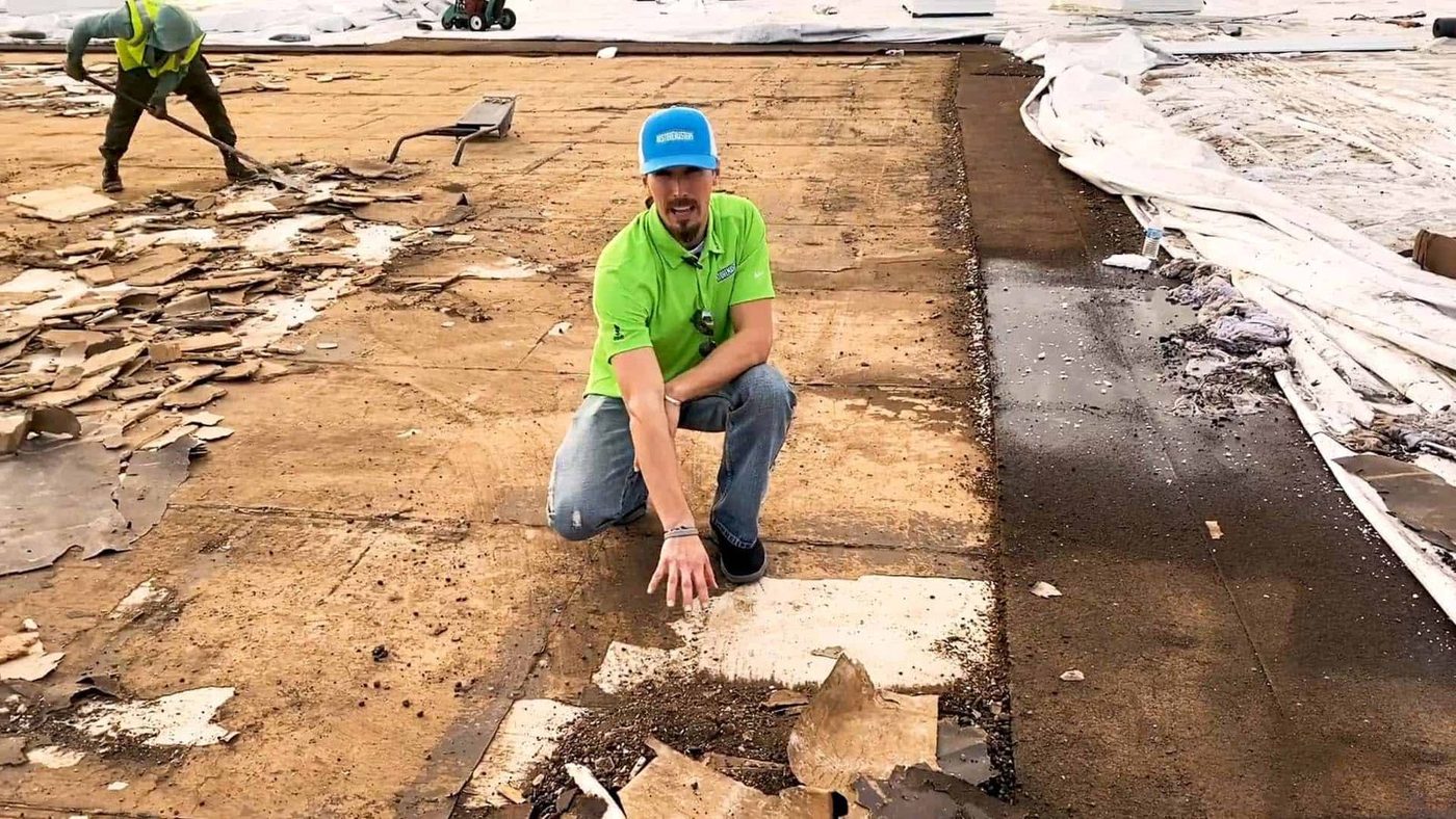 Storm-damaged flat roof opened up to the deck.